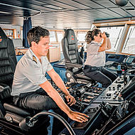 Male and female captain on the bridge of the HSC Tarifa Jet.